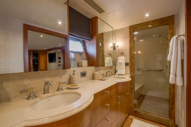 Front Row Yacht Photos Pics Luxurious bathroom in 2006 Northcoast Yachts Yachtfisher, featuring dual sinks and glass shower.