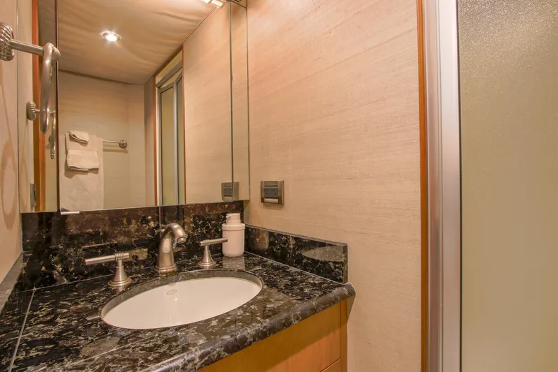 Front Row Yacht Photos Pics Luxurious bathroom in 2006 Northcoast Yachts Yachtfisher with marble countertop and modern fixtures.