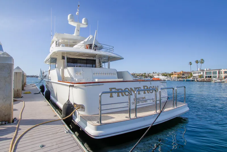 Front Row Yacht Photos Pics 2006 Northcoast Yachts Yachtfisher docked at marina, clear blue sky, waterfront homes.