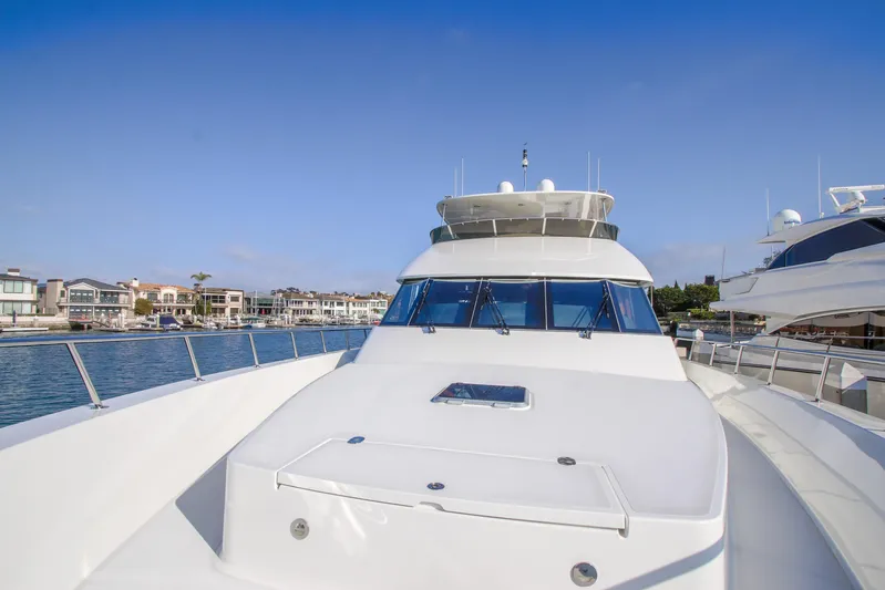 Front Row Yacht Photos Pics 2006 Northcoast Yachts Yachtfisher on calm water, with waterfront homes in the background.