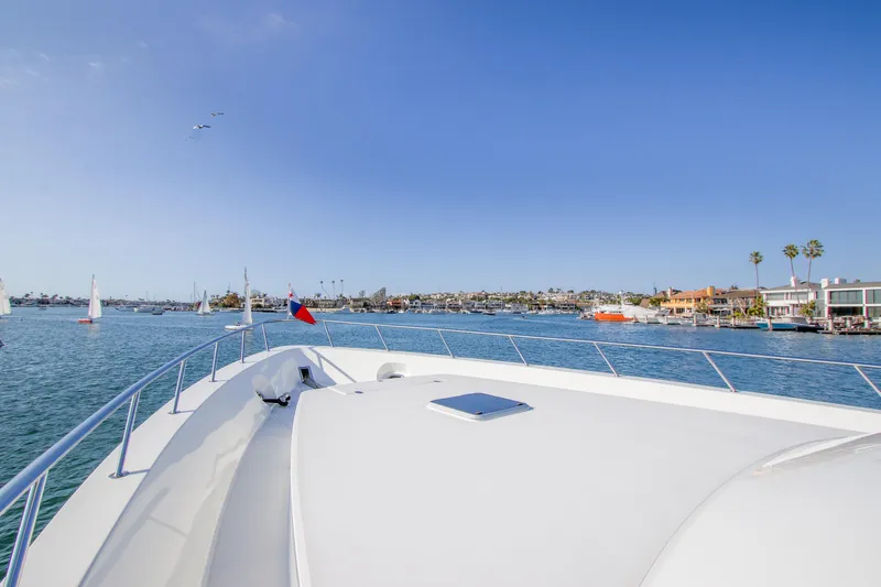 Front Row Yacht Photos Pics 2006 Northcoast Yachts Yachtfisher cruising in a scenic harbor with clear blue skies.
