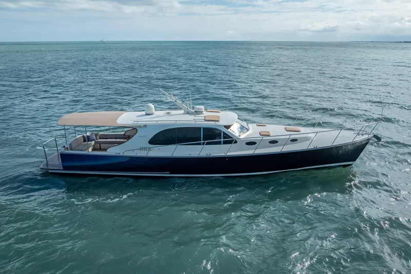 Stella Yacht Photos Pics 2018 Palm Beach Motor Yachts PB50 cruising on open water under a cloudy sky.