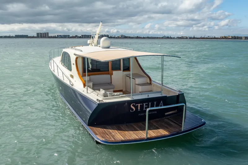 Stella Yacht Photos Pics 2018 Palm Beach Motor Yachts PB50 cruising on calm waters under cloudy skies.