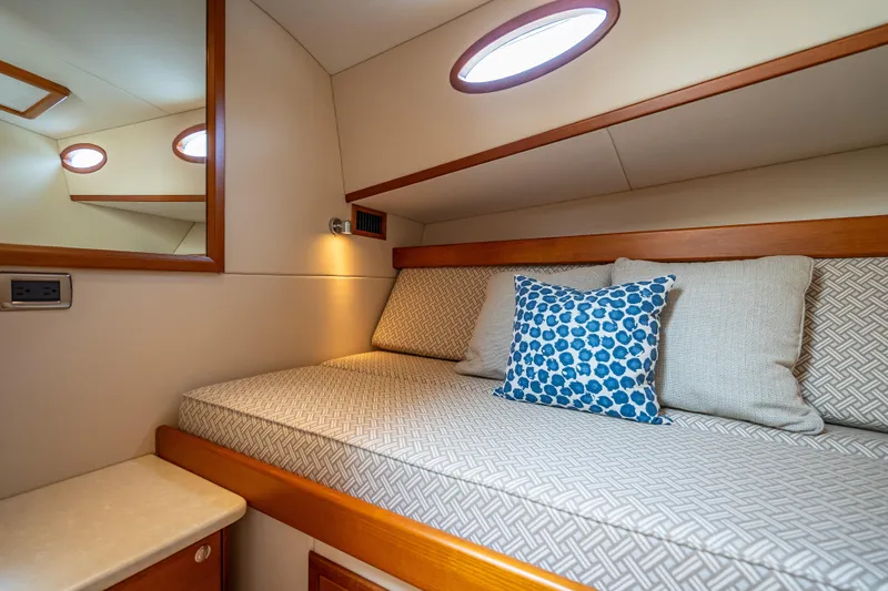 Stella Yacht Photos Pics Luxurious cabin interior of 2018 Palm Beach Motor Yachts PB50 with cozy bedding and cushions.