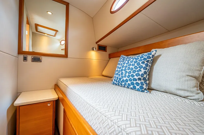 Stella Yacht Photos Pics Luxurious cabin interior of 2018 Palm Beach Motor Yachts PB50 with cozy bedding and elegant decor.
