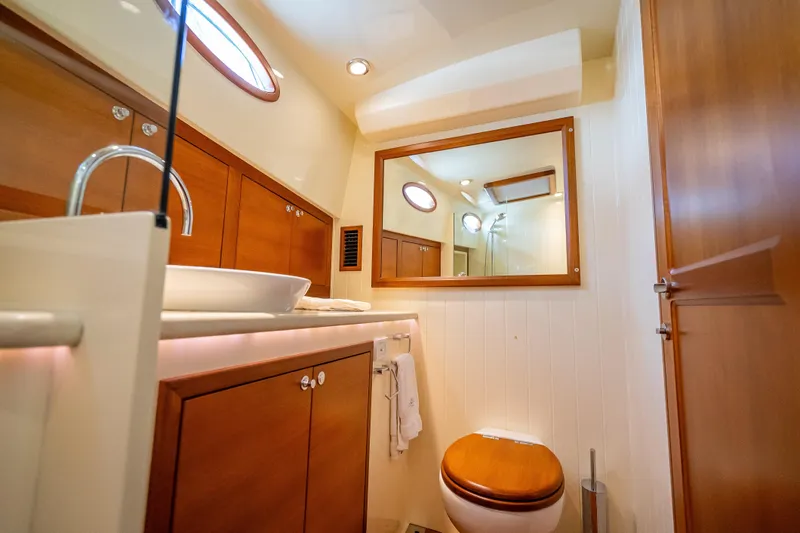 Stella Yacht Photos Pics Luxurious bathroom interior of 2018 Palm Beach Motor Yachts PB50, featuring wood accents and modern fixtures.