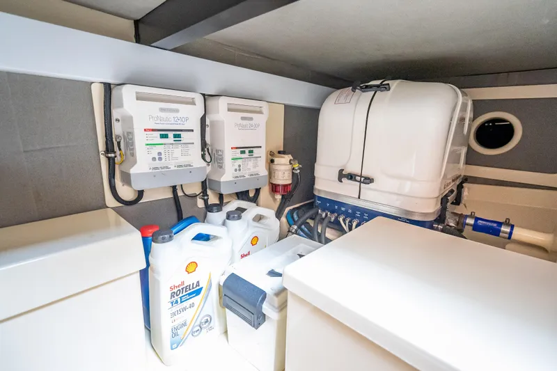 Stella Yacht Photos Pics Engine room of 2018 Palm Beach Motor Yachts PB50 with equipment and oil containers.