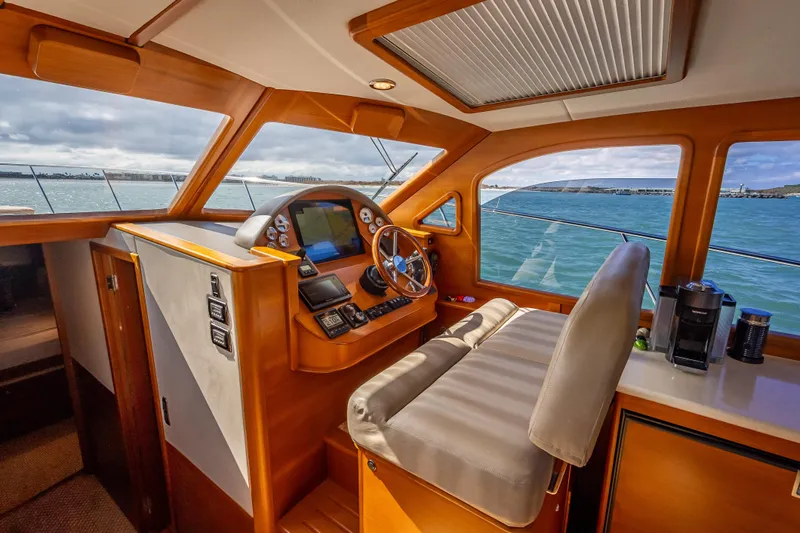 Stella Yacht Photos Pics 2018 Palm Beach Motor Yachts PB50 helm with wooden interior and ocean view.