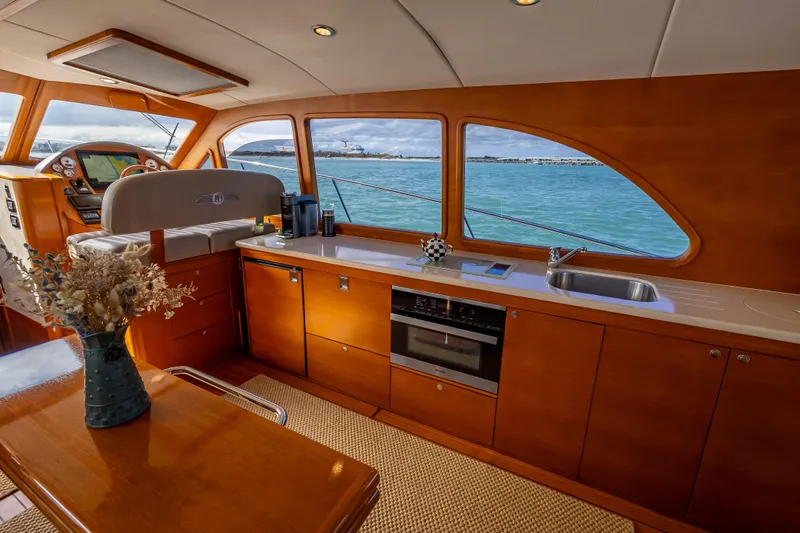Stella Yacht Photos Pics Luxurious interior of 2018 Palm Beach Motor Yachts PB50 with elegant wood finish and ocean view.