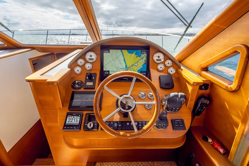 Stella Yacht Photos Pics 2018 Palm Beach Motor Yachts PB50 helm with navigation instruments and wooden steering wheel.