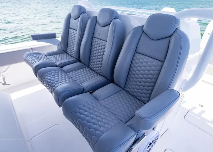  Yacht Photos Pics Luxurious seating on 2025 Invincible 43 Open Fisherman boat, featuring stylish blue upholstery.