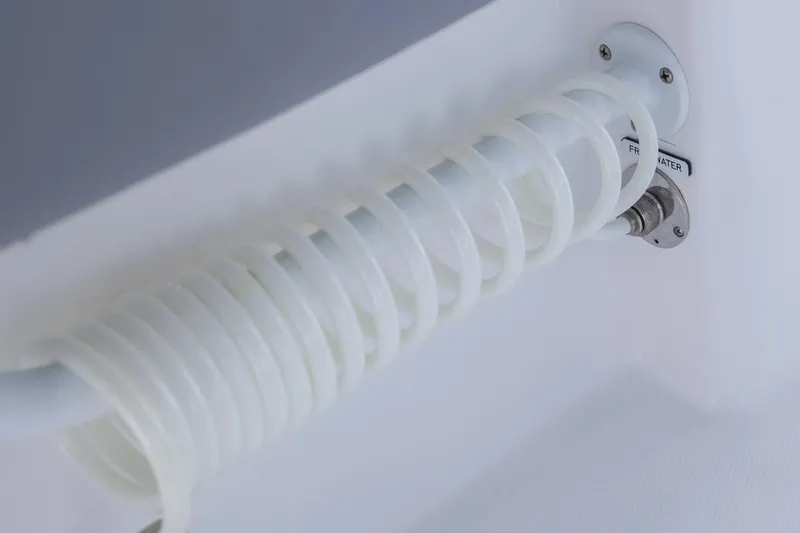  Yacht Photos Pics Coiled hose on 2025 Invincible 43 Open Fisherman boat, labeled "Fresh Water."