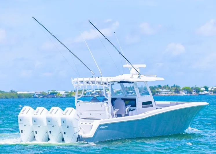  Yacht Photos Pics 2025 Invincible 43 Open Fisherman boat cruising on blue water with four engines.