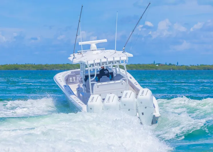  Yacht Photos Pics 2025 Invincible 43 Open Fisherman cruising on blue ocean waters.