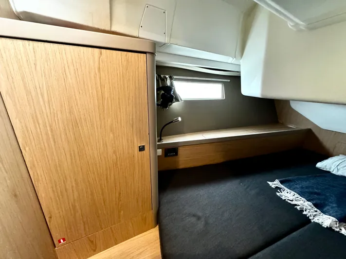  Yacht Photos Pics Cozy cabin interior of 2018 Beneteau Oceanis 45 sailboat with wooden finishes.