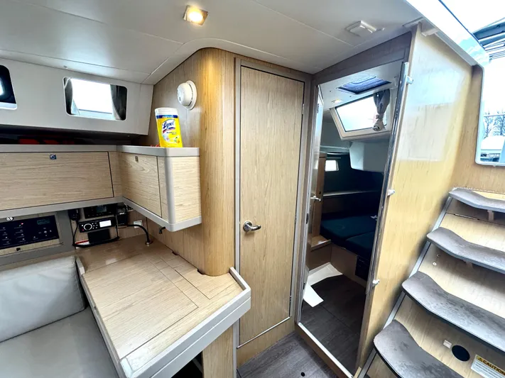  Yacht Photos Pics Interior of 2018 Beneteau Oceanis 45 yacht, featuring modern wood cabinetry and compact design.
