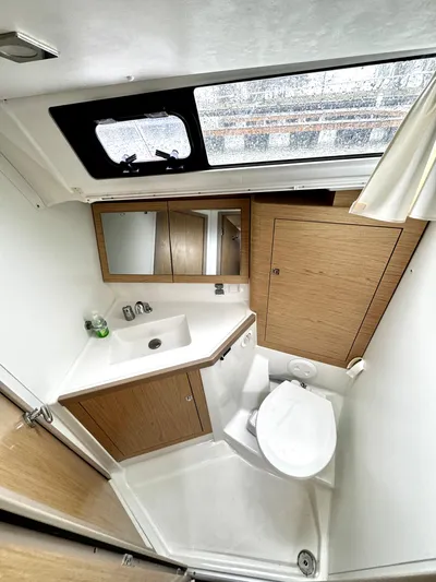  Yacht Photos Pics 2018 Beneteau Oceanis 45 yacht bathroom with modern fixtures and wood accents.