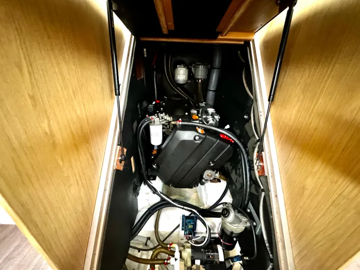  Yacht Photos Pics Engine compartment of a 2018 Beneteau Oceanis 45 sailboat, showcasing mechanical components.