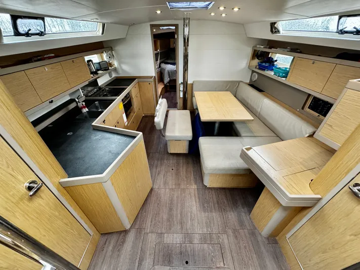  Yacht Photos Pics Interior of 2018 Beneteau Oceanis 45 yacht with modern kitchen and dining area.