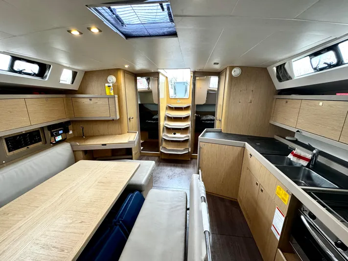  Yacht Photos Pics Interior of 2018 Beneteau Oceanis 45 yacht, featuring modern kitchen and dining area.