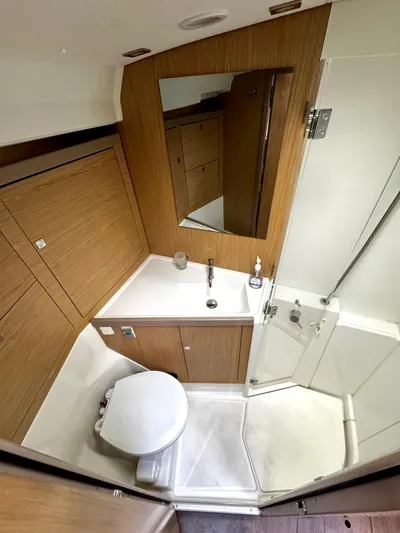  Yacht Photos Pics 2018 Beneteau Oceanis 45 bathroom with wood paneling, shower, and modern fixtures.