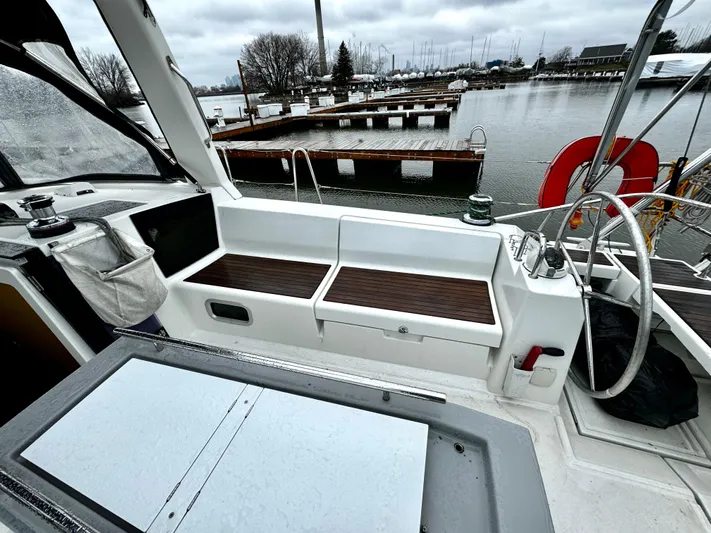  Yacht Photos Pics Beneteau Oceanis 45 cockpit with seating, steering wheel, and marina view, 2018 model.