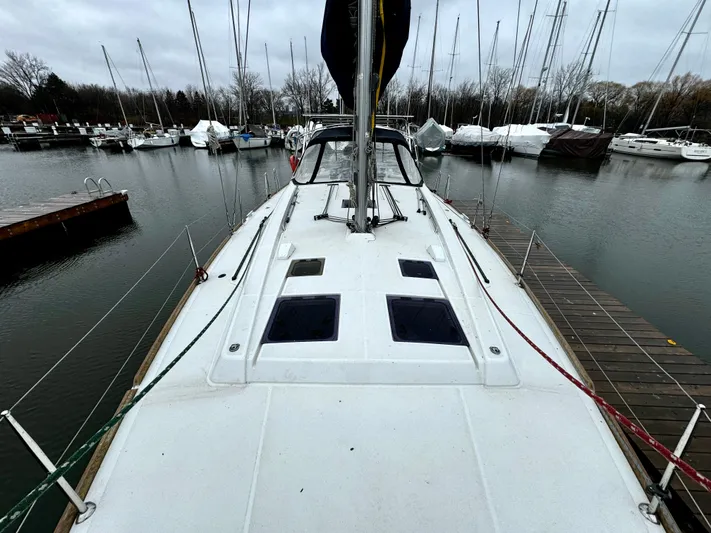  Yacht Photos Pics 2018 Beneteau Oceanis 45 sailboat docked in a marina, overcast sky.