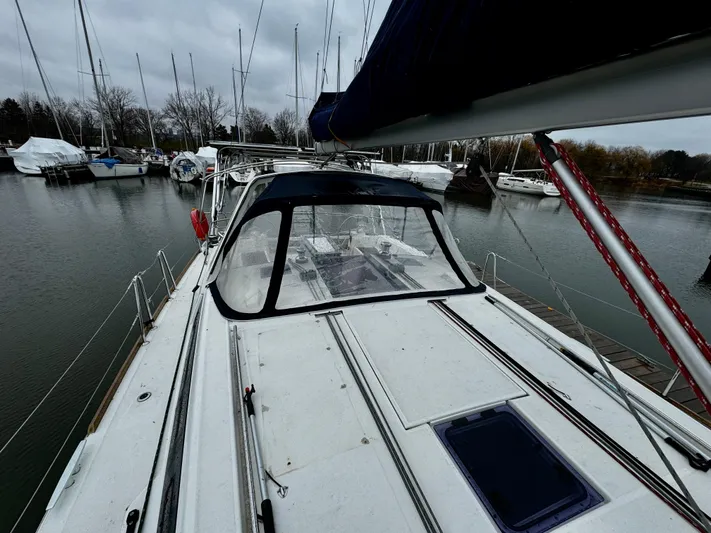  Yacht Photos Pics 2018 Beneteau Oceanis 45 sailboat docked in a marina on a cloudy day.