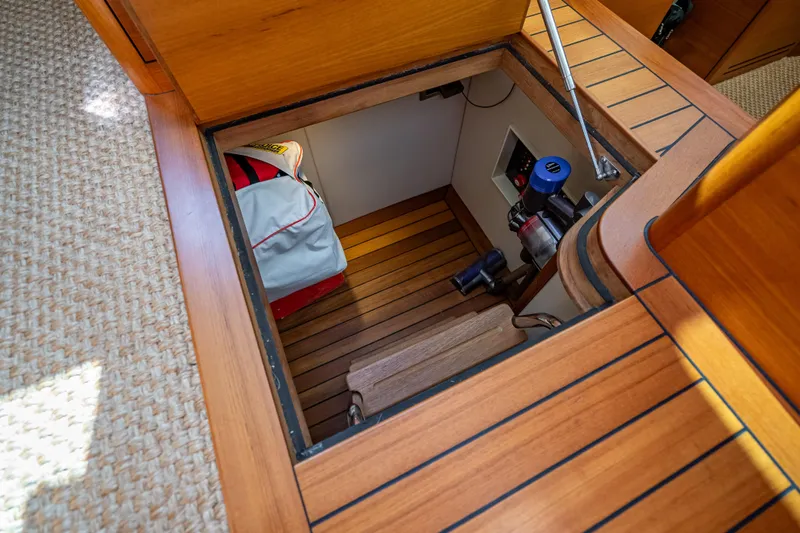 Eleven11 Yacht Photos Pics 2018 Palm Beach Motor Yachts PB55 interior storage compartment with wooden flooring and equipment.