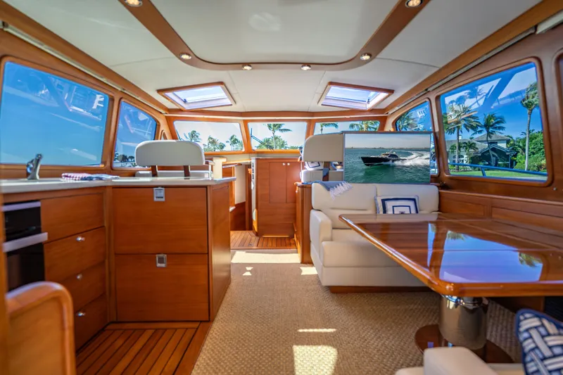 Eleven11 Yacht Photos Pics Luxurious interior of 2018 Palm Beach Motor Yachts PB55 with elegant wood finishes and plush seating.