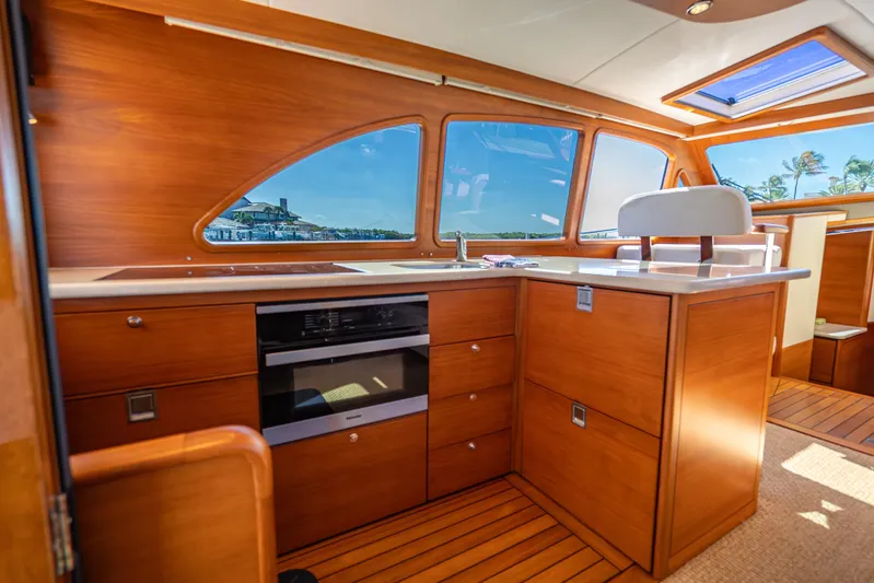 Eleven11 Yacht Photos Pics Luxurious interior of 2018 Palm Beach Motor Yachts PB55 with wooden cabinetry and scenic windows.