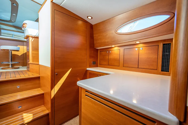 Eleven11 Yacht Photos Pics Luxurious interior of 2018 Palm Beach Motor Yachts PB55 with wooden cabinetry and modern design.