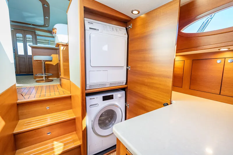 Eleven11 Yacht Photos Pics Laundry area inside 2018 Palm Beach Motor Yachts PB55, featuring Miele washer and dryer.