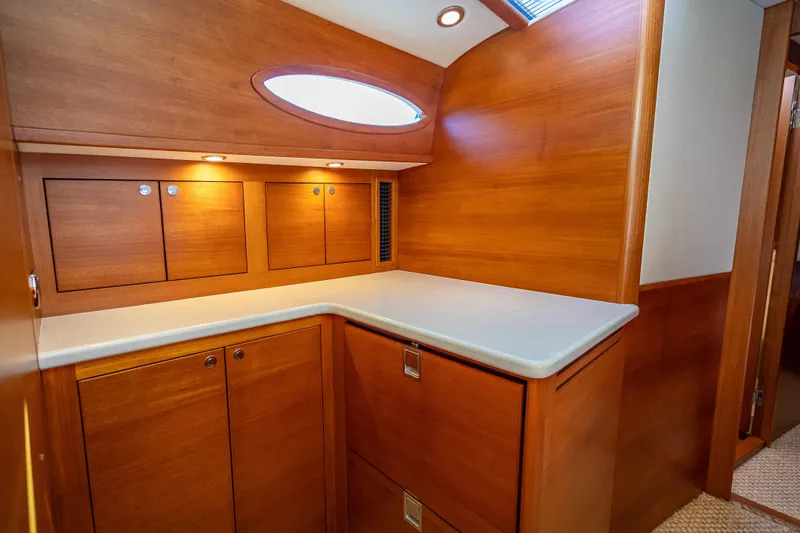 Eleven11 Yacht Photos Pics Luxurious wooden interior of 2018 Palm Beach Motor Yachts PB55, featuring elegant cabinetry and lighting.