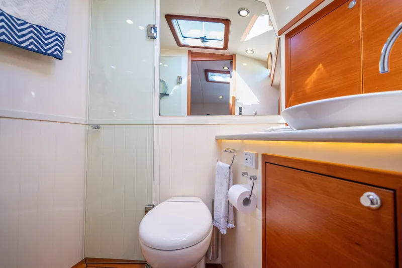 Eleven11 Yacht Photos Pics Luxurious bathroom interior of 2018 Palm Beach Motor Yachts PB55, featuring modern fixtures and wood accents.