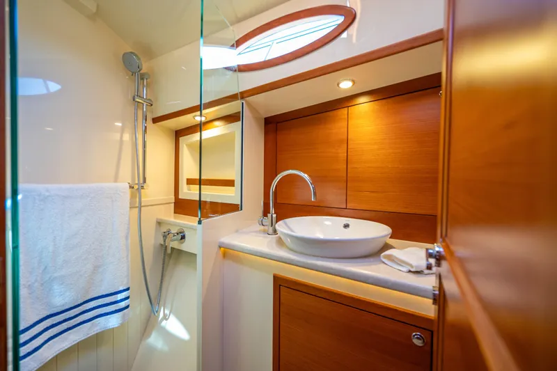 Eleven11 Yacht Photos Pics Luxurious bathroom in 2018 Palm Beach Motor Yachts PB55, featuring modern fixtures and elegant wood finishes.