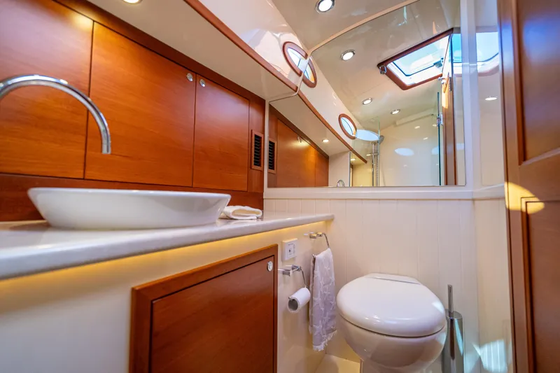 Eleven11 Yacht Photos Pics Luxurious bathroom interior of 2018 Palm Beach Motor Yachts PB55, featuring elegant wood finishes.