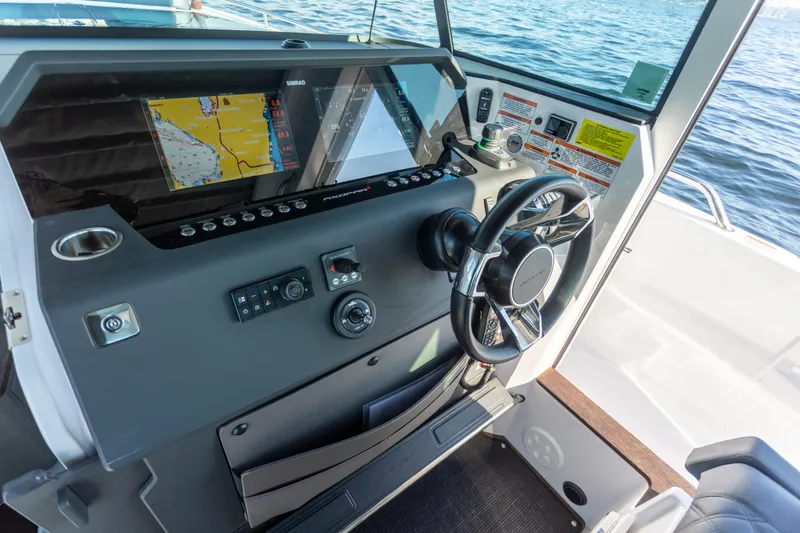  Yacht Photos Pics Helm of 2021 Axopar 37XC Aft Cabin with navigation display and steering wheel.