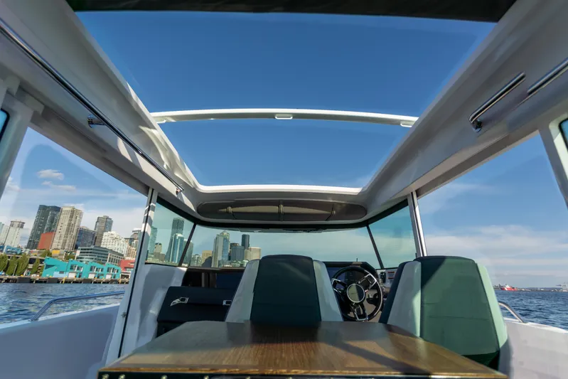  Yacht Photos Pics Interior view of 2021 Axopar 37XC Aft Cabin with city skyline in background.