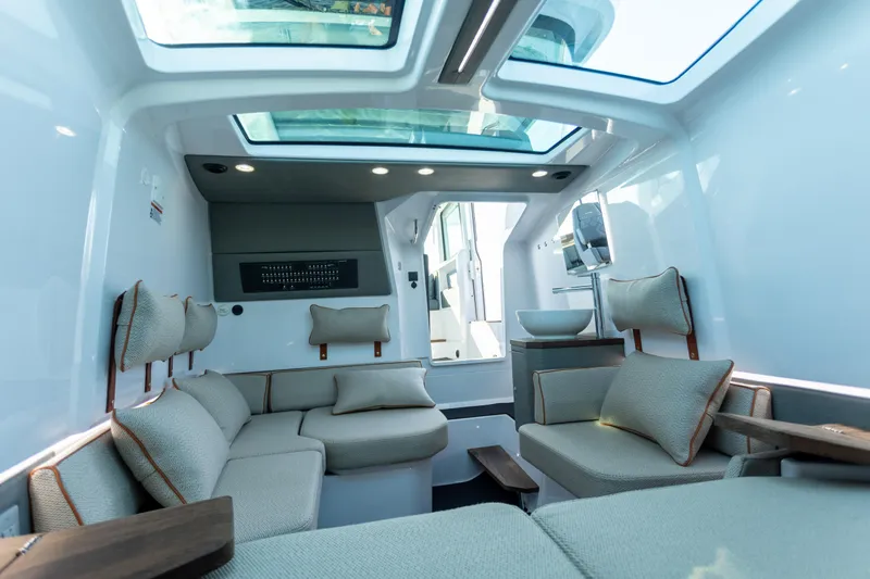  Yacht Photos Pics Luxurious interior of 2021 Axopar 37XC Aft Cabin with modern seating and skylight.