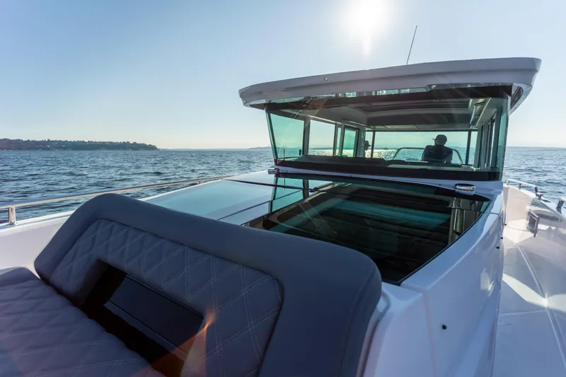  Yacht Photos Pics 2021 Axopar 37XC Aft Cabin cruising on open water under clear skies.