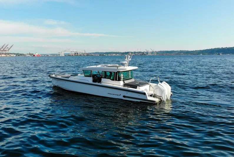  Yacht Photos Pics 2021 Axopar 37XC Aft Cabin boat cruising on open water.