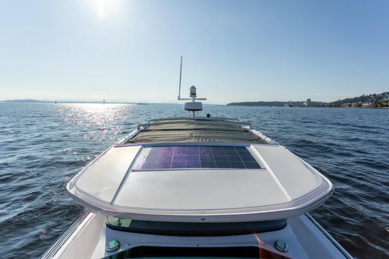  Yacht Photos Pics 2021 Axopar 37XC Aft Cabin cruising on a sunny day, featuring a solar panel.
