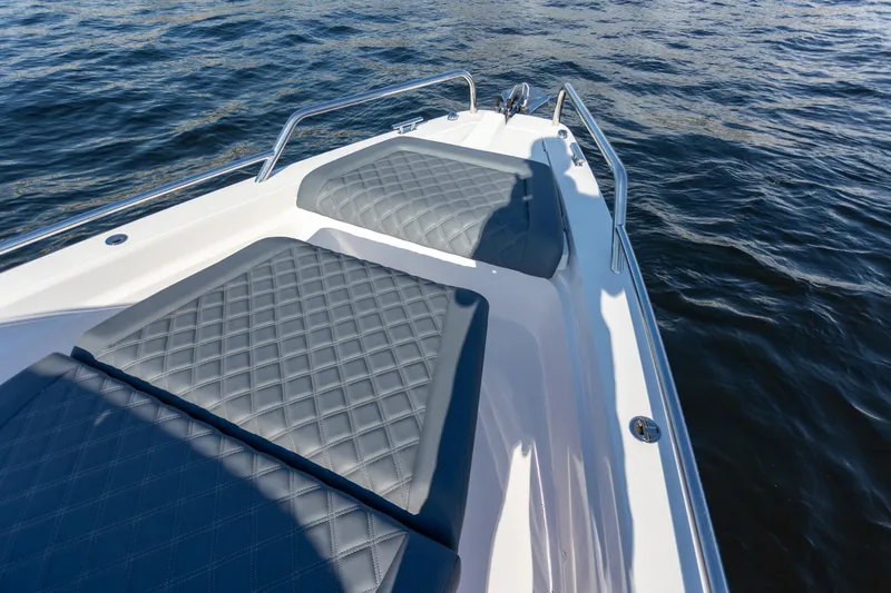  Yacht Photos Pics Bow seating area on 2021 Axopar 37XC Aft Cabin, featuring quilted cushions.