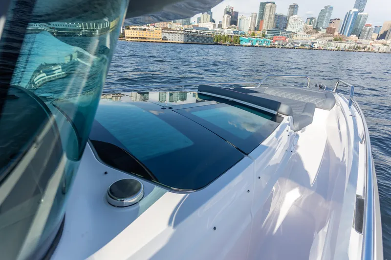  Yacht Photos Pics 2021 Axopar 37XC Aft Cabin boat cruising near city skyline.