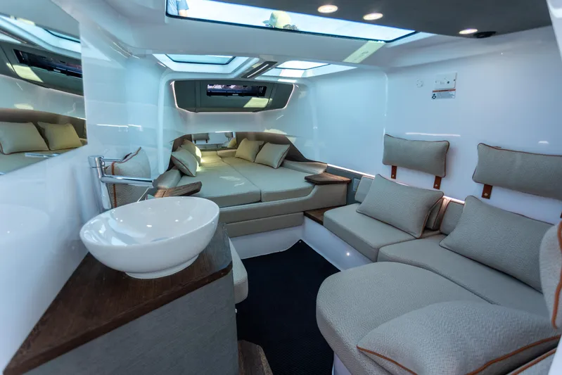  Yacht Photos Pics Luxurious interior of 2021 Axopar 37XC Aft Cabin with modern seating and skylight.