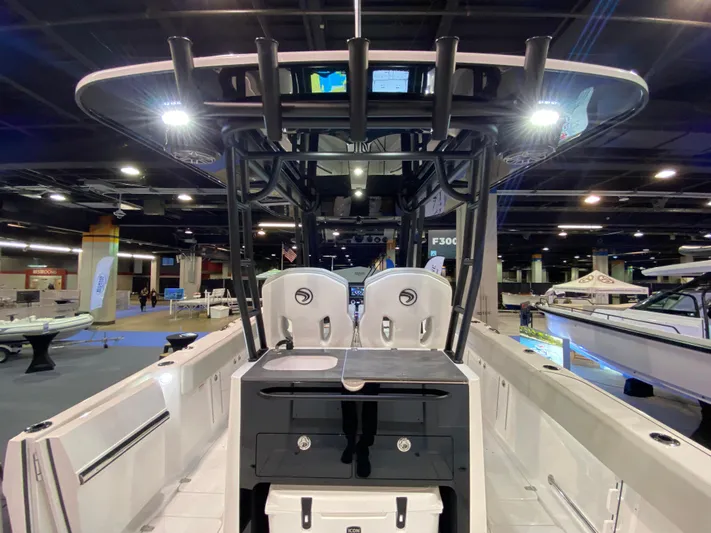  Yacht Photos Pics 2025 Edgewater 340CC boat interior at a showroom, featuring modern seating and controls.
