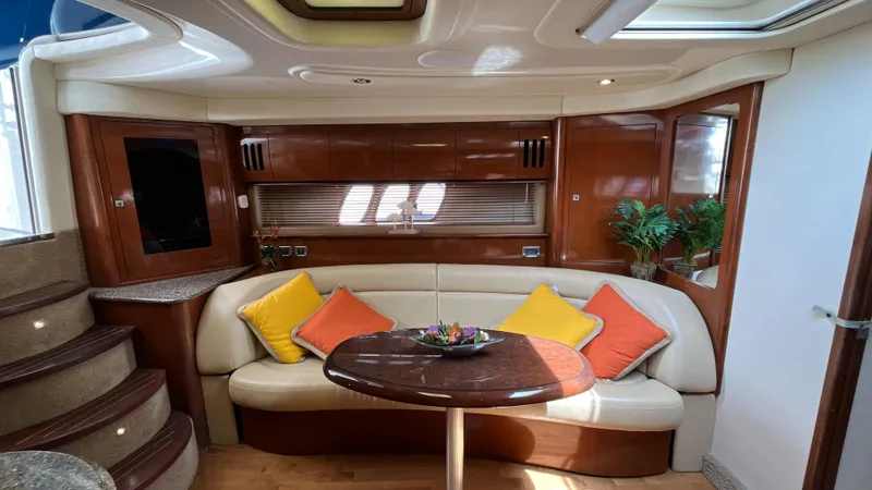 Lowest Price In Usa Yacht Photos Pics 2008 Sea Ray 44 Sundancer interior with plush seating, wooden table, and vibrant cushions.