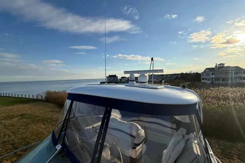 Yacht Photos Pics 2006 Formula 40 Performance Cruiser docked by a scenic waterfront at sunset.