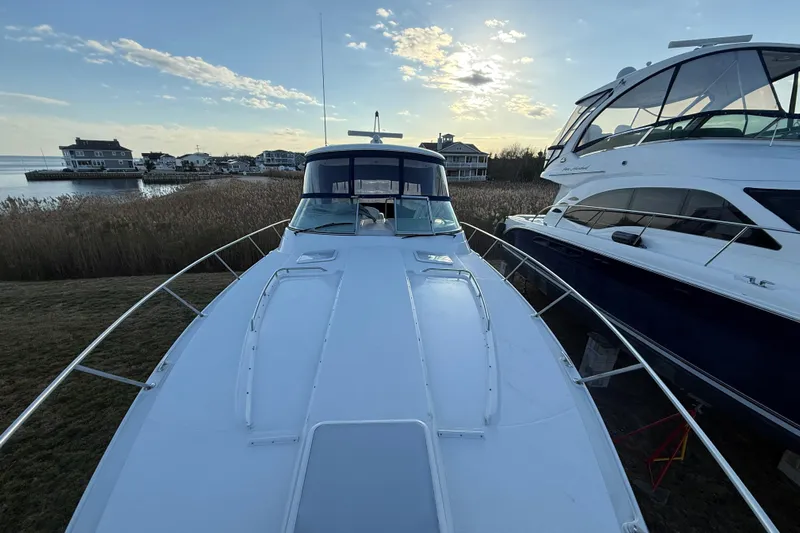  Yacht Photos Pics 2006 Formula 40 Performance Cruiser docked near waterfront homes at sunset.